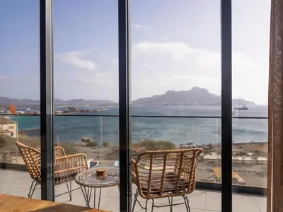 a view of the ocean from the balcony of a house at Suncent apartment in Mindelo