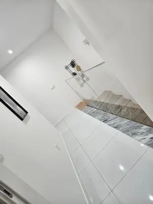a room with a white ceiling and a staircase at T3 Duplex - Palmarejo Grande in Praia