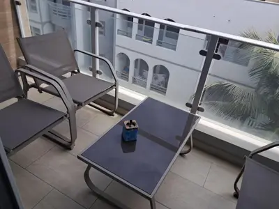 a couple of chairs and a table on a balcony at Boavista Estoril Residence Sol & Mar in Sal Rei