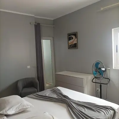 a bedroom with a bed and a chair and a mirror at Boavista Estoril Residence Sol & Mar in Sal Rei