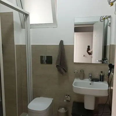 a bathroom with a sink and a toilet and a mirror at Boavista Estoril Residence Sol & Mar in Sal Rei