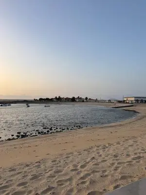 a beach with a body of water with boats in it at Murdeira V17 RC by RPG Group in Beirona