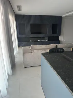 a living room with a couch and a flat screen tv at Boa Vista Apartment in Prainha
