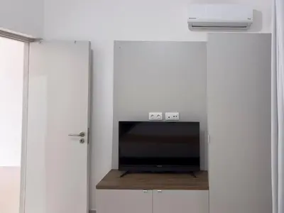 a living room with a tv in a white wall at Cozy apt amazing seaview - 2 min from beach - LCGR in Tarrafal