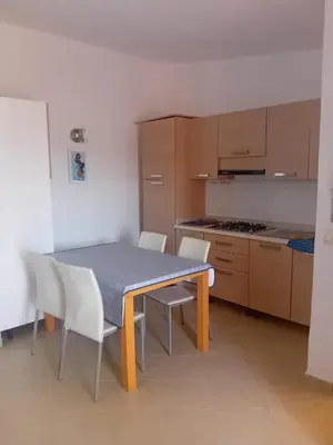 a kitchen with a table and chairs and a kitchen with a stove at Casa Mendonça in Santa Maria