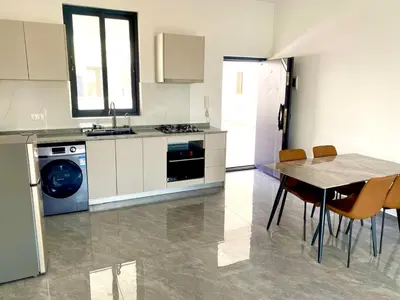 a kitchen with a table and a kitchen with a dishwasher at APARTAMENTO 403 T2 Centro de Sal Rei, Boavista in Sal Rei
