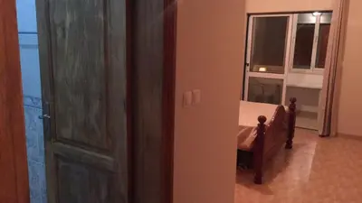 a door leading to a bedroom with a bed and a window at Comfortable private room in Assomada in Assomada