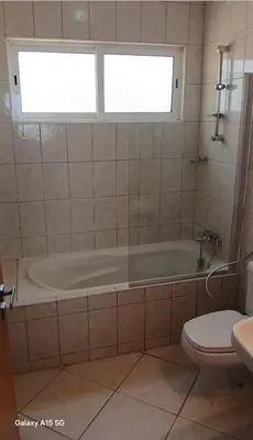 a bathroom with a tub and a toilet and a window at Pandora Ocena View II in Sal Rei