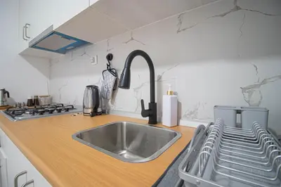 a kitchen with a sink and a counter top at Modern Gateway in Santa Maria