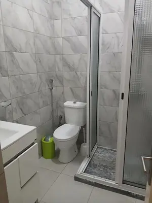a bathroom with a toilet and a glass shower at Mar&Cruz in Mindelo