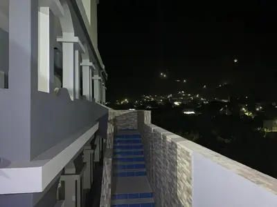 a stairway leading up to a building at night at Djabraba's Trail Triple SUITE in Vila Nova Sintra