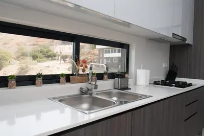 a kitchen counter with a sink and a window at Santa Ocean View in Mindelo