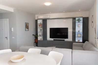 a living room with a couch and a tv at Santa Ocean View in Mindelo