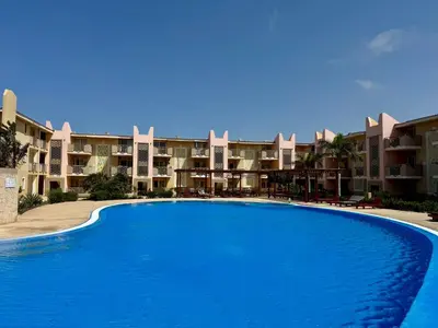 a large swimming pool in front of some apartments at Tropical Mar Profundo in Santa Maria