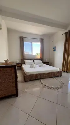 a bedroom with a large bed and a large window at Estrella Do Mar Santa Maria in Santa Maria