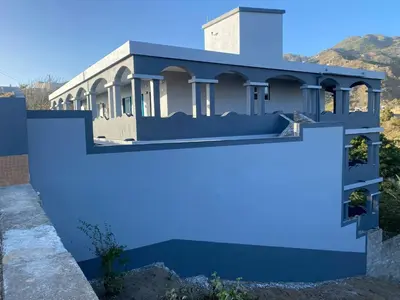 a house painted blue with a fence at Djabraba's Boarding Rooms in Garça