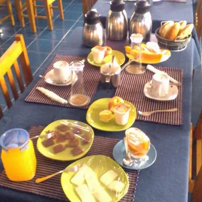 a blue table with plates of food on it at Djabraba's Boarding Rooms in Garça