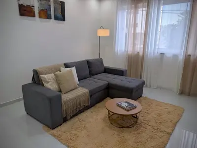 a living room with a couch and a coffee table at Modern and Stylish 1BR Apt - Cidadela - Ground Floor in Praia