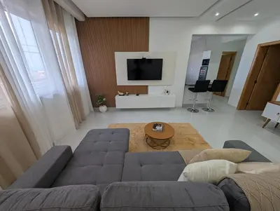 a living room with a couch and a table at Modern and Stylish 1BR Apt - Cidadela - Ground Floor in Praia