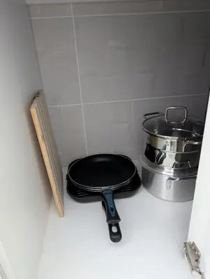 a pot and pans sitting on a counter in a kitchen at Modern and Stylish 1BR Apt - Cidadela - Ground Floor in Praia