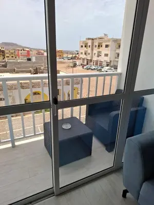 a balcony with a table and a view of a city at Apartamentos Fatynybal in Espargos