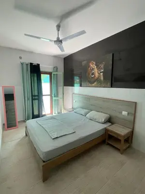a bedroom with a bed with a painting on the wall at Djadsal Moradias - Near the ocean in Santa Maria
