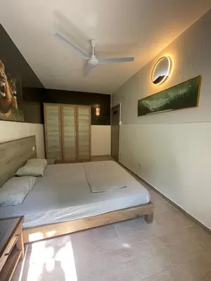 a bedroom with a bed and a ceiling fan at Djadsal Moradias - Near the ocean in Santa Maria
