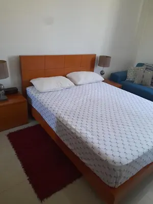 a bedroom with a bed with a white comforter at Conforto in Praia