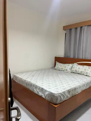 a bedroom with a bed with a wooden headboard at Aconchego da Bety in Praia