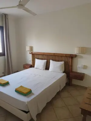 a bedroom with a bed with two towels on it at Marialva Tropical T1 in Santa Maria