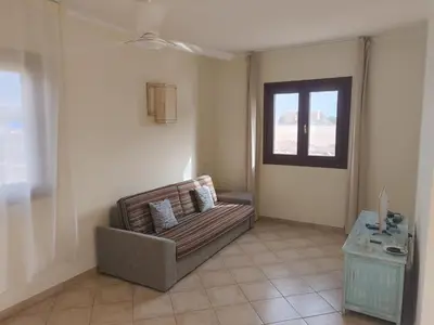 a living room with a couch and a window at Marialva Tropical T1 in Santa Maria
