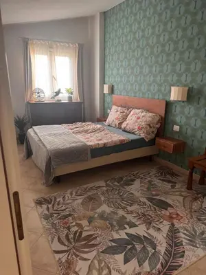 a bedroom with a bed and a rug at Tropical Anzso in Santa Maria