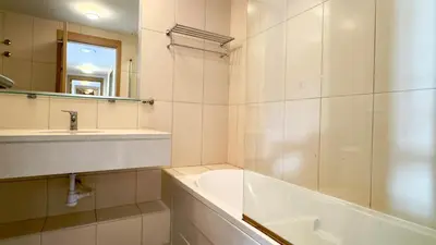 a bathroom with a tub and a sink and a bath tub at Exclusive 3-Bedroom Apartment Vila Verde Resort in Santa Maria