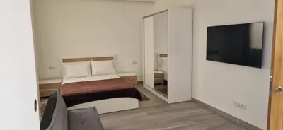a bedroom with a bed and a large mirror at Ines Studio T0 - Inforsal in Espargos