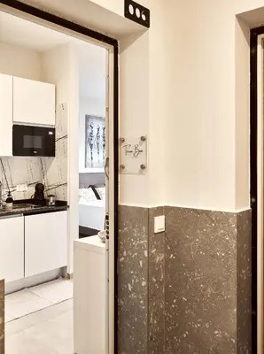 a kitchen with white cabinets and a glass door at Terra Boa beach apartment Sal Cabo Verde in Santa Maria
