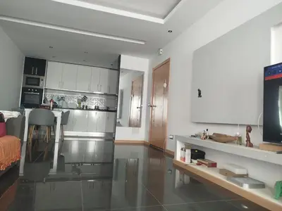 a kitchen with white cabinets and a table in a room at Sofia Évora Spínola in Cova Figueira