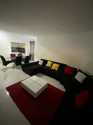 a living room with a bed and a red rug at Cozy Apartment, 3 Bedrooms in Praia