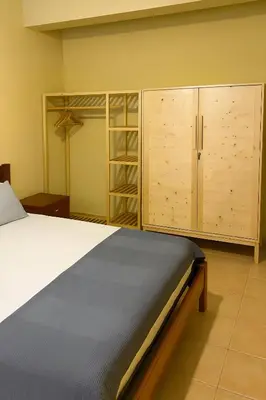 a bedroom with a bed and some wooden cabinets at Casa di Mar in Santa Maria