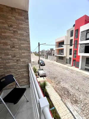 a balcony of a building with a chair and a street at Casa BB&Djassi - Apartment T3 in Ponta do Sol
