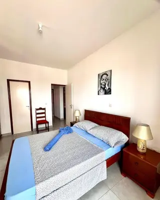 a bedroom with a bed with a blue blanket on it at Casa BB&Djassi - Apartment T3 in Ponta do Sol