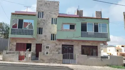 an old stone house on the side of the street at Sossego & Conforto in Espargos