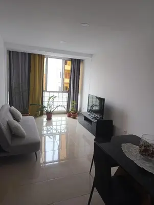 a living room with a couch and a television at Sossego & Conforto in Espargos