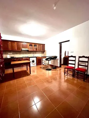 a kitchen with a table and chairs in a room at Casa BB&Djassi - Apartment T1 in Ponta do Sol