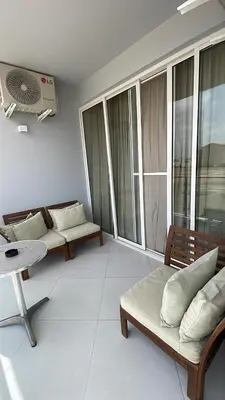 a living room with two couches and a table and windows at Apartamentos Esperança in Sal Rei
