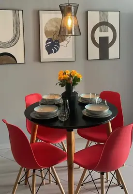 a dining room table with red chairs and a lamp at Apartamentos Esperança in Sal Rei