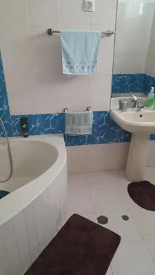 a bathroom with a bath tub and a sink at Apart SilvaGomes in Praia