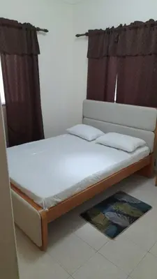 a bed with two pillows on it in a room at Apart SilvaGomes in Praia
