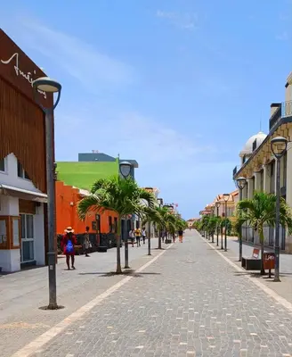 a cobblestone street with palm trees and buildings at Cosy 2 Bed Apartment Vila Verde Santa Maria in Santa Maria