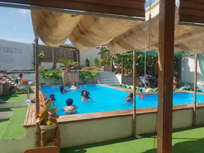 a group of people in a swimming pool at Quinta Refúgio in Ribeirão Chiqueiro
