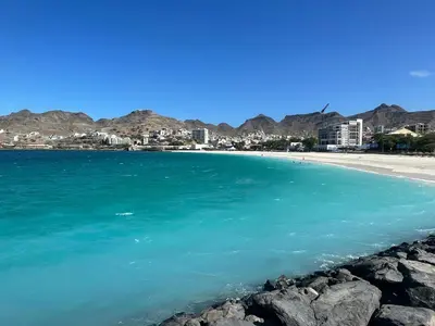 a view of a beach with mountains in the background at Mindelo Bay Apartment in Mindelo